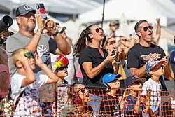 Adults and children looking up at the sky to watch aerial performances