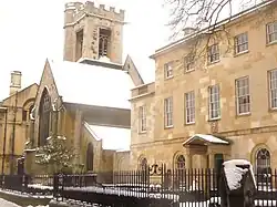 The Church of St Peter-le-Bailey, now the chapel of St Peter's College, on the left and the college porter's lodge on the right, in New Inn Hall Street