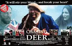 Brian Blessed in triumphal pose in highland dress, flanked by characters from the film