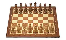 Staunton chess pieces on chess board