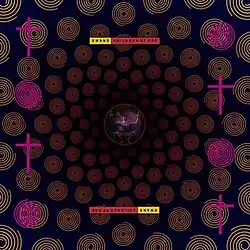 Yellow spirals emanate from a circle containing a figure wearing a black mask with a yellow cross on it in the center of the album art. On the left and right sides pink crosses and spirals alternate.