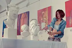 Chinese model posing as an artist smashing a sculpture