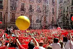 Seconds before the beginning of the San Fermín Festival—Town Hall Square: Everybody has a red handkerchief above their heads until a firework is exploded at 12 pm; putting it around their neck afterward