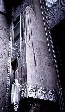 Detail of one of the entrance portals, which is decorated with a miniature model of the building