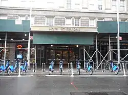 The Clark Street entrance to the Hotel St. George and the Clark Street subway station on the IRT Broadway-Seventh Avenue Line in Brooklyn Heights. A CitiBike rental station is located in front of the entrance.