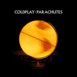 A close-up photograph of a yellow globe in a darkened room. The globe is spinning and illuminated from the inside. The words "COLDPLAY • PARACHUTES" are written in white text above the globe to indicate the artist and album name.