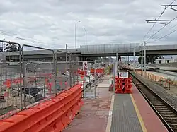 A railway station platform with parts fenced off for construction