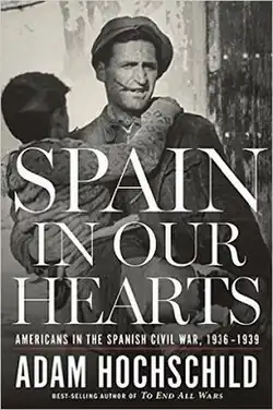 The first edition cover of Spain in Our Hearts shows a vintage photograph of an adult man carrying a young boy in his arms during the Spanish Civil War.