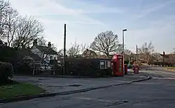 Road junction with red telephone box and white-painted public house