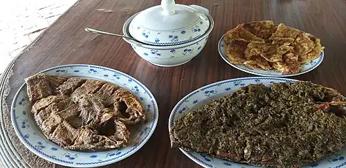 River fish layered with ground mustard leaves.