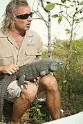 Blue iguana (Cyclura lewisi), The warden is educating tourists about the iguana, Queen Elizabeth II Botanic Park