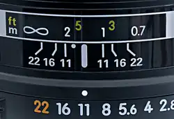 Detail from a lens set to f/11. The point half-way between the 1 m and 2 m marks, the DOF limits at f/11, represents the focus distance of approximately 1.33 m (the reciprocal of the mean of the reciprocals of 1 and 2 being 4/3).