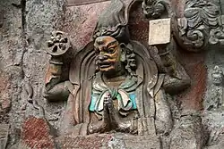 Carved cliff relief of Yamāntaka, one out of a set depicting the Ten Wisdom Kings, at the Dazu Rock Carvings in Chongqing, China. 7th century.