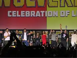 Picture of the film's cast and crew together on a stage in 2024