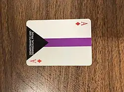 An ace of diamonds with the words “DEMIROMANTIC AND DEMISEXUAL PRIDE” on it and demisexual flag colors in the background, part of a display for International Asexuality Day set up in Pennsylvania in 2025.