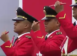 Drummers of the Band of the National Police of Peru pictured circa 2017 in scarlet parade uniforms