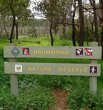 Old CALM sign with various labels, marsh area of south west corner in background