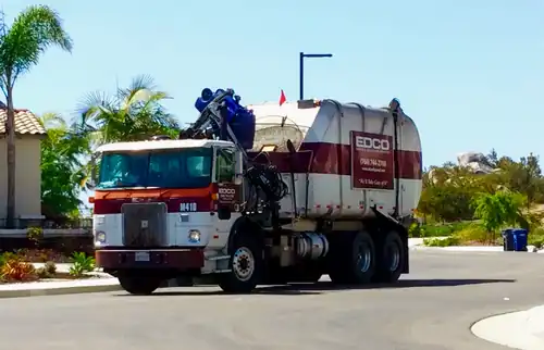 An EDCO Heil Rapid Rail automated side loader collecting trash in Vista, California, US.