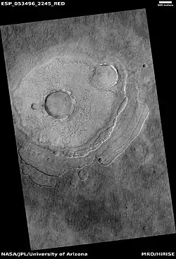 Pedestal crater, as seen by HiRISE under HiWish program Scallops are forming at the bottom edge of the pedestal. Location is Casius quadrangle.