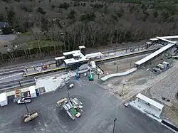 An aerial view of a railway station with two footbridges under construction