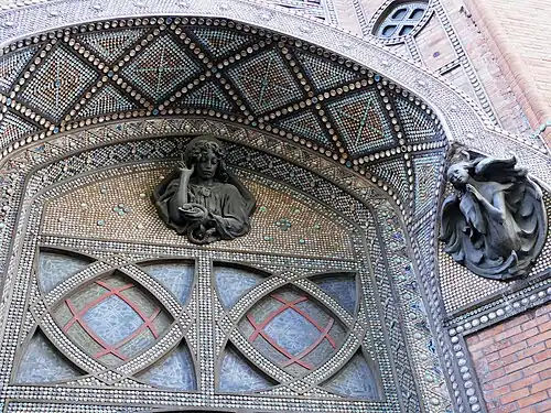 Detail of ceramic decoration and sculpture of the portal.