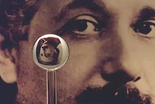 An image of one of the most accurate human-made spheres, as it refracts the image of Einstein in the background. This sphere was a fused quartz gyroscope for the Gravity Probe B experiment, and differs in shape from a perfect sphere by no more than 40 atoms (less than 10 nm) of thickness. It was announced on 1 July 2008 that Australian scientists had created even more nearly perfect spheres, accurate to 0.3 nm, as part of an international hunt to find a new global standard kilogram.[21]