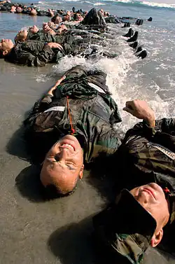 First Phase Trainees endure surf torture. Future Medal of Honor recipient Michael Monsoor is shown in the lower right corner.