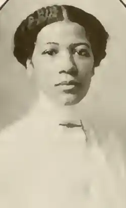 A young Black woman wearing a white blouse, in an oval frame