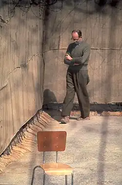 Adolf Eichmann pacing alone in an outdoor enclosure