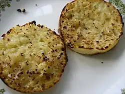 The halved muffins are usually toasted and spread with butter, often accompanied by jelly, jam, or honey.