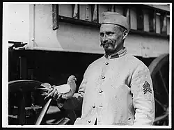 A French homing pigeon and its trainer