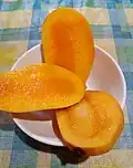 Fully ripe Chok Anan mango cut into three pieces.