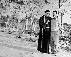 Execution of Arístidez Díaz in Manzanillo, assisted by Father José Luis Sarragoitia Lazpica. Behind are bodies, recently executed. (January 12, 1959).