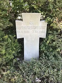 white headstone bearing the name Helmut Lent and dates 13 June 1918, 7 October 1944