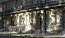 A Georgian-style terrace house (townhouse) with the number 21 on one of its doors