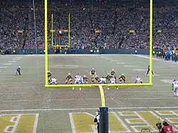 Packers and Giants players lining up on the field near the end zone