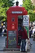 A Glasgow police box (red variation of a Mackenzie Trench) near the Glasgow Royal Concert Hall serving as a hemp dispensary