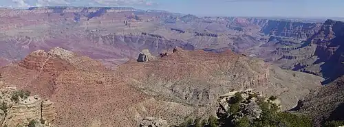 Wide canyon with exposed red- and tan-colored rock