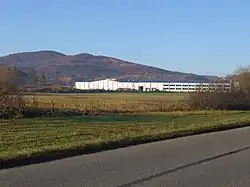 Grodzisko Mountain. In the foreground, the packaging factory in Zegartowice