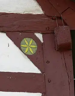 Half-timbered house in Rommersheim (Germany) with apotropaic rosette