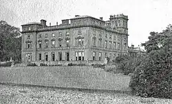 Black-and-white photograph of Haveringland Hall seen from across a lake