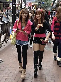 Image 4Young women in Hong Kong wearing layered street style with accessories and hairstyles influenced by Japanese gyaru and J-pop aesthetics, 2013. (from 2010s in fashion)