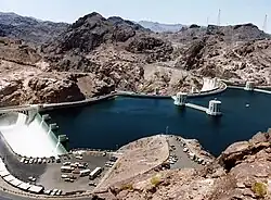 Water enters Hoover Dam's Arizona side channel drum-gate spillway (left) during the 1983 floods