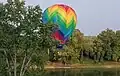 Hot air balloon dips low over the Wabash River