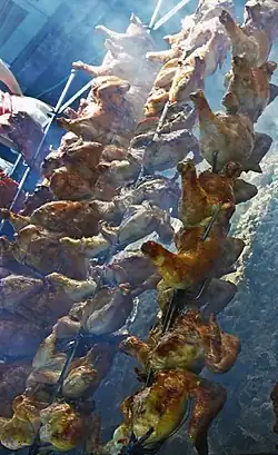 Huli-huli chicken roasting on spits