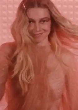 Schafer is performing an advertisement and turns her head to the camera