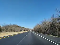 Driver's view of a straight, flat, four-lane divided highway