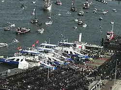 4 ferries moored at the Amsterdam Central Station. In the background on the right is an old ferry, then used as a bicycle shed. August 2015.