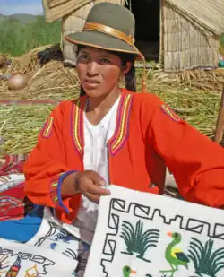 A Uro woman showing her crafts.