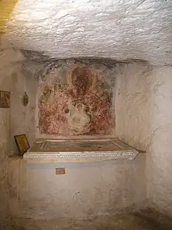 Interior of the altar of the Aghia Kyriaki stone Church at Angelokastro featuring the smaller of the two Early-Christian closure slabs as its altar stone
